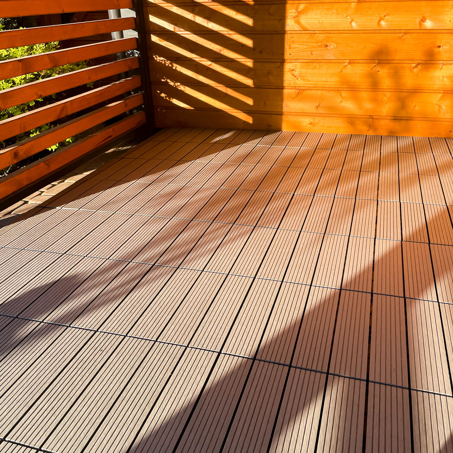 Terrace with Standard composite deck tiles in a grey shade