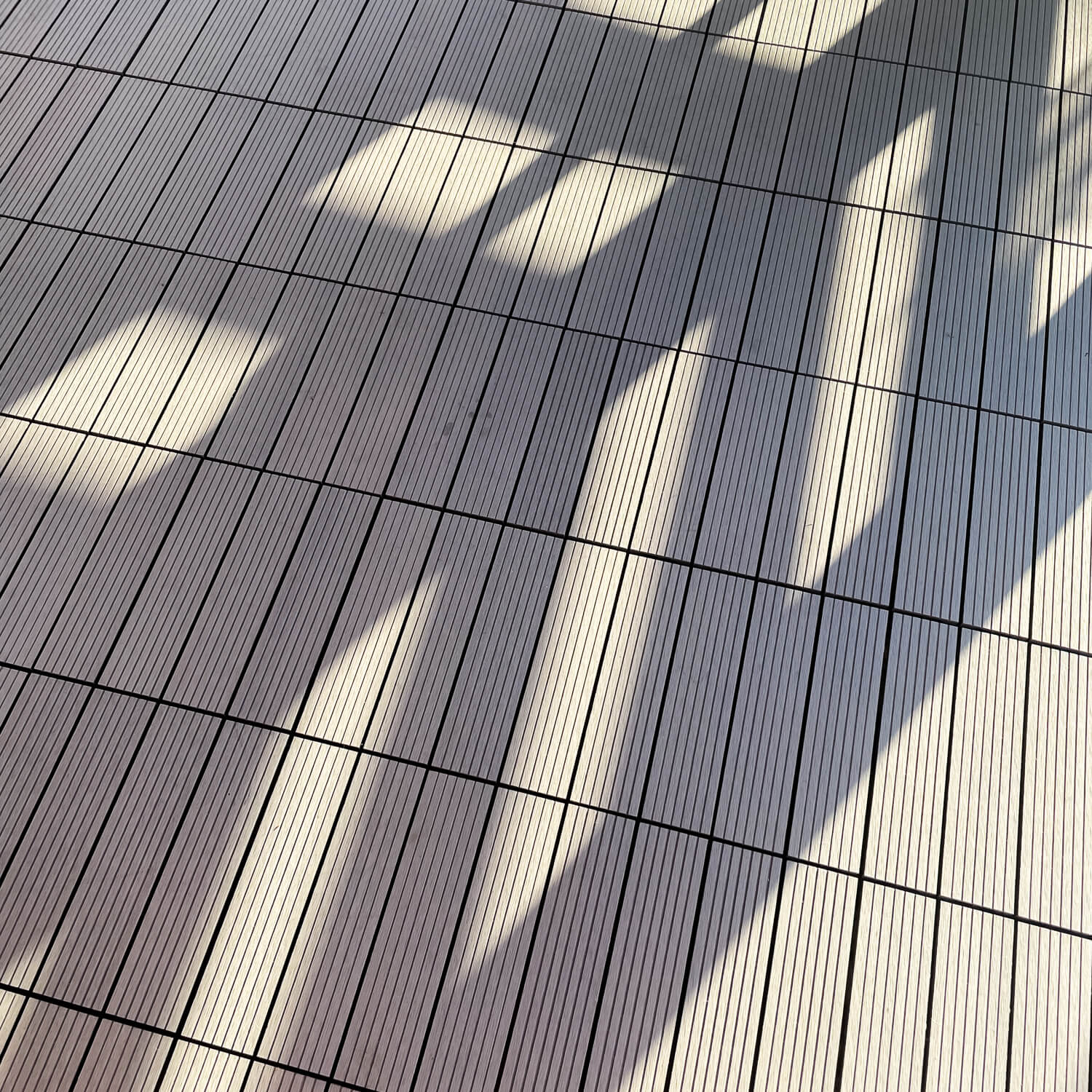 Terrace with Standard composite deck tiles in a grey shade