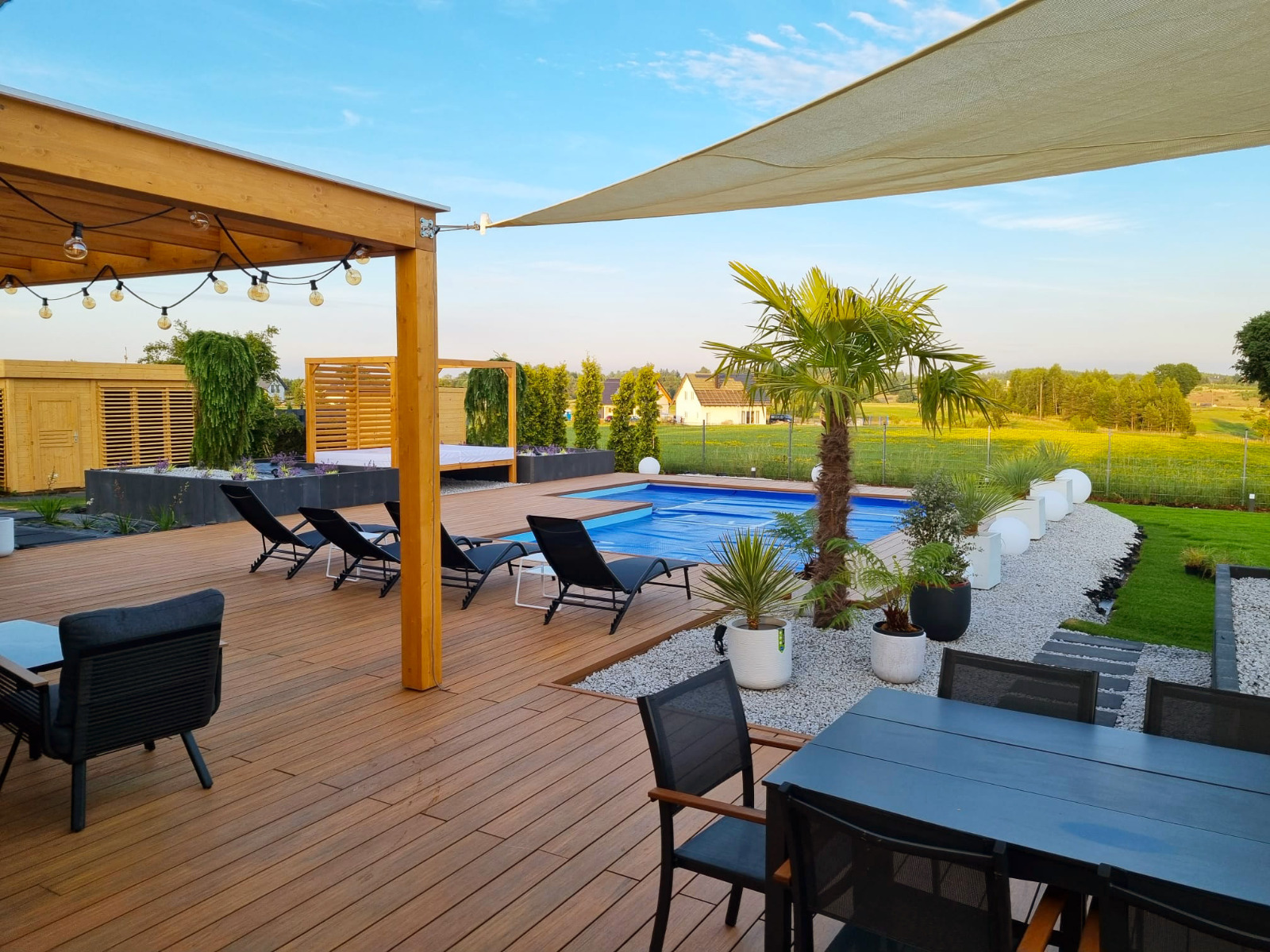 Luxury terrace made of Premium Amber composite decking with a pool