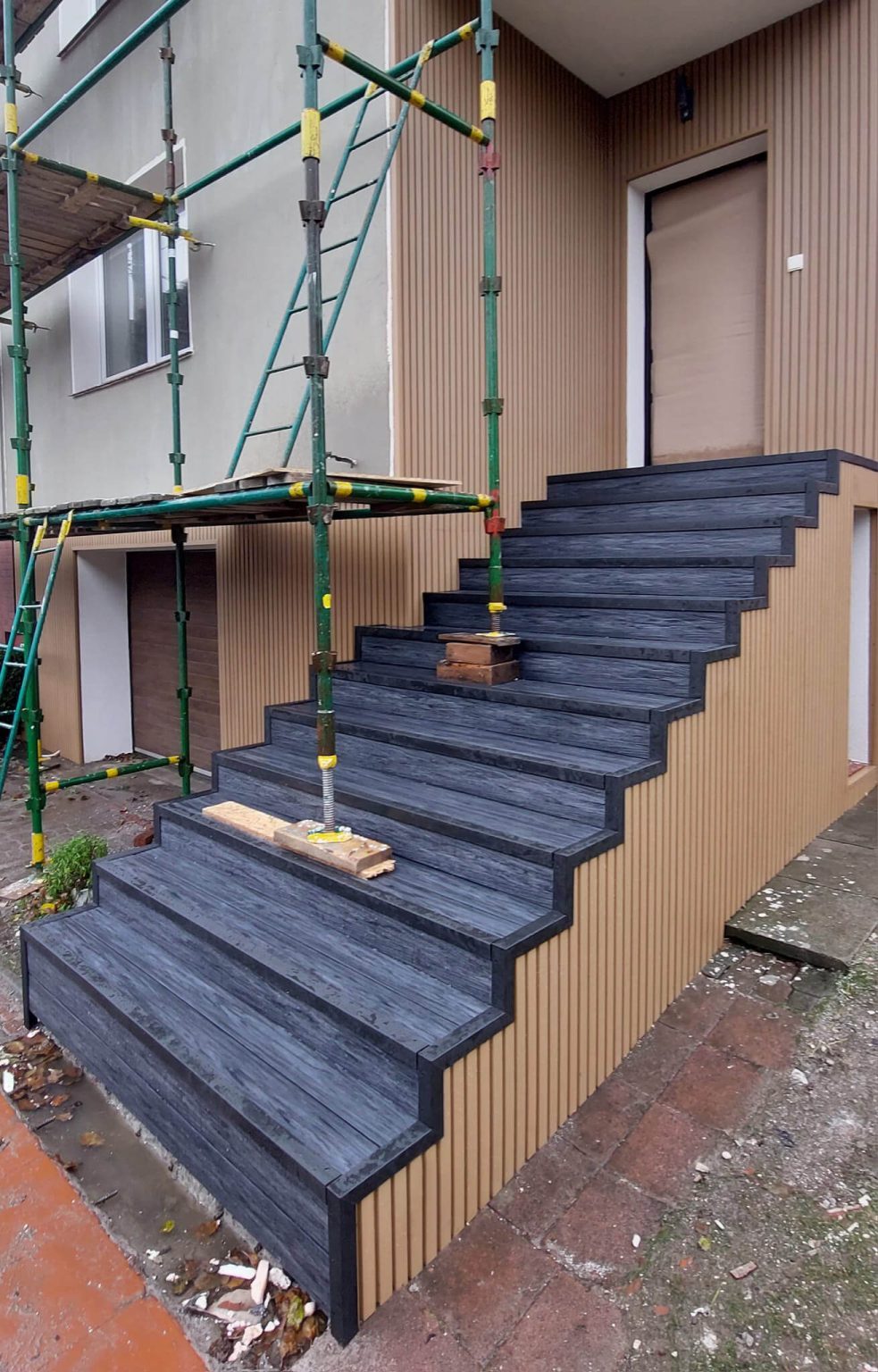 Stairs made out of composite decking boards (Premium Anthracite) and cladding slats (Premium Oak)